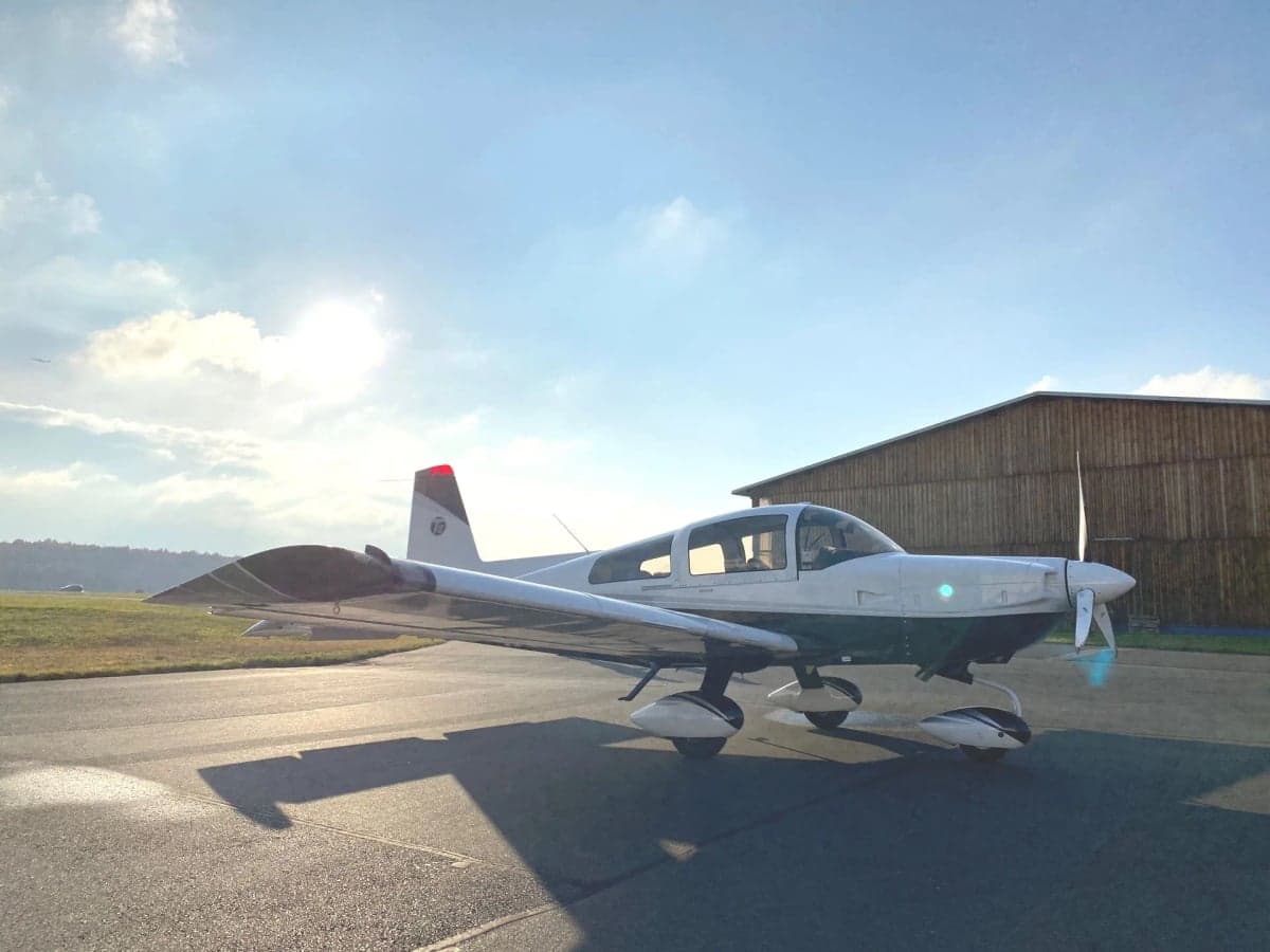 N6554B aircraft parked on the tarmac in front of a hangar.