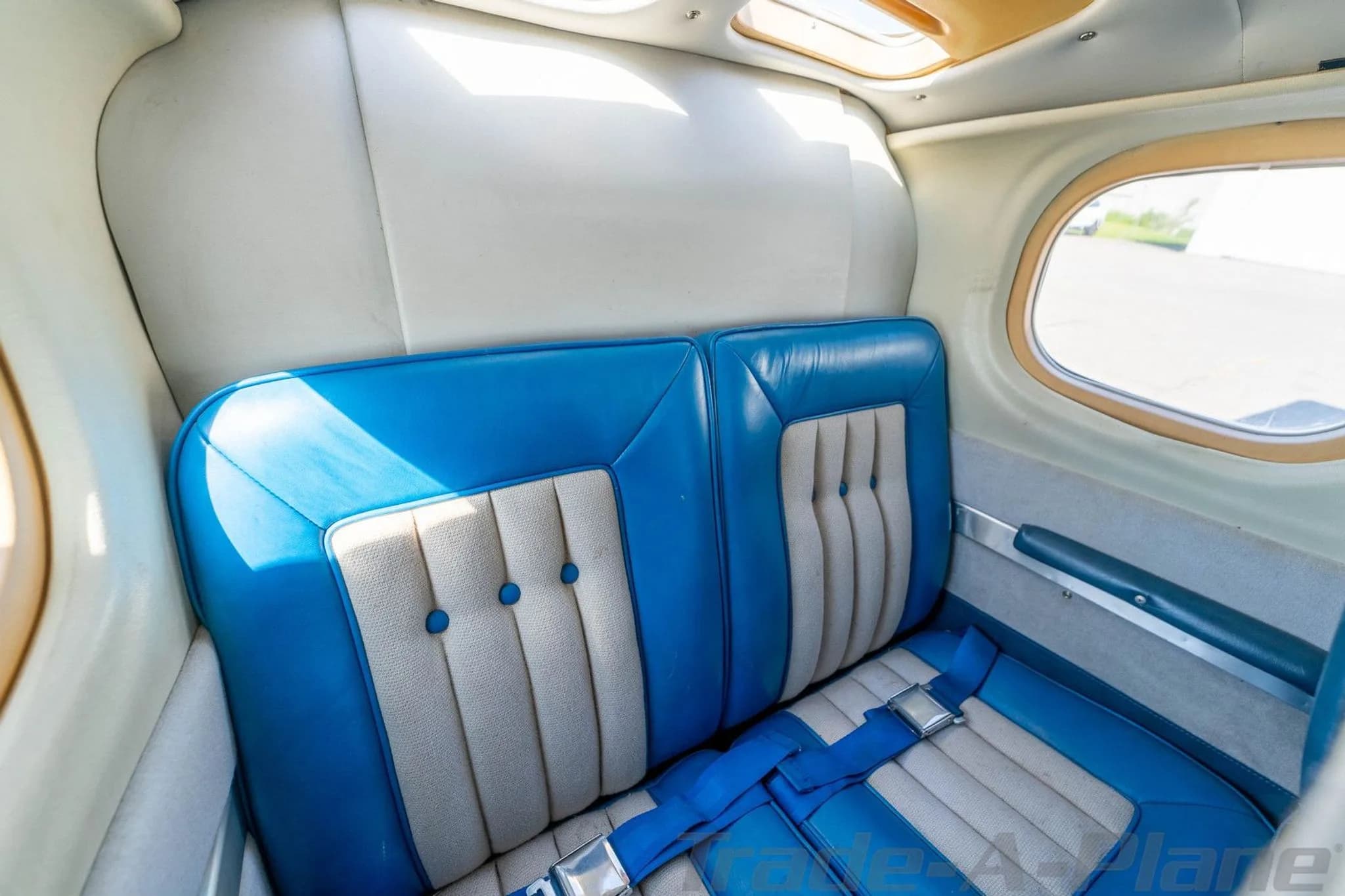 A close-up view of the rear blue and light gray passenger seats in the aircraft's cabin.