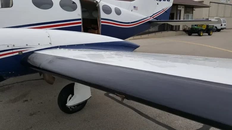 A small thumbnail of a white and blue twin-engine Cessna 414 Chancellor aircraft (N1996G) parked on an airfield.