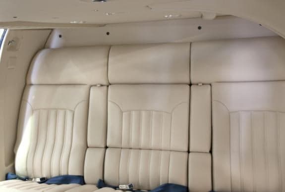 Close-up of the cream-colored leather seats in the helicopter cabin.