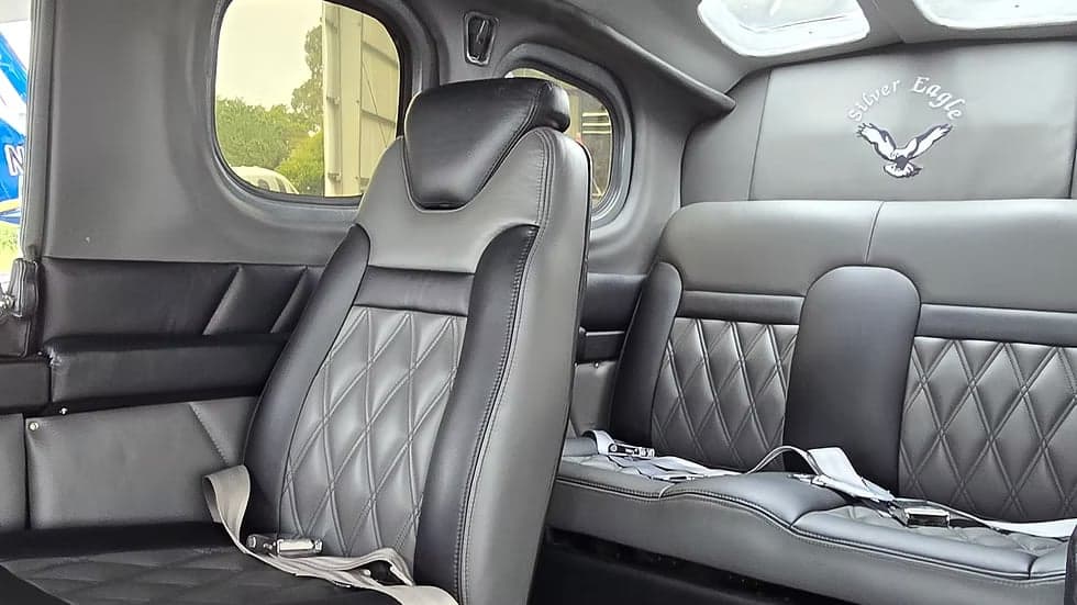 Interior view of the Cessna Caravan, showcasing the leather seats with diamond stitching and the 'Silver Eagle' logo.