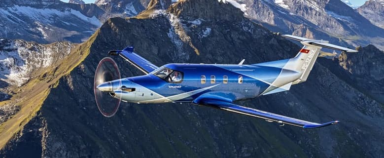 Pilatus PC-12 NGX in flight over mountains.