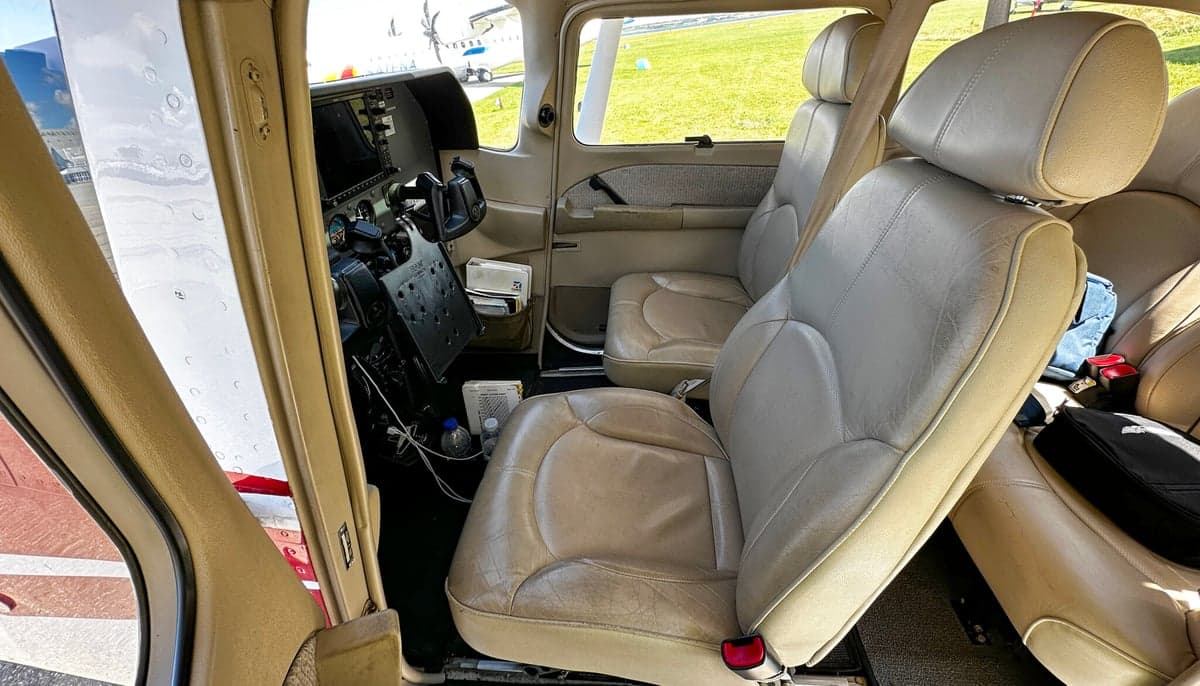 The interior of the aircraft, showing the front seats and instrument panel.