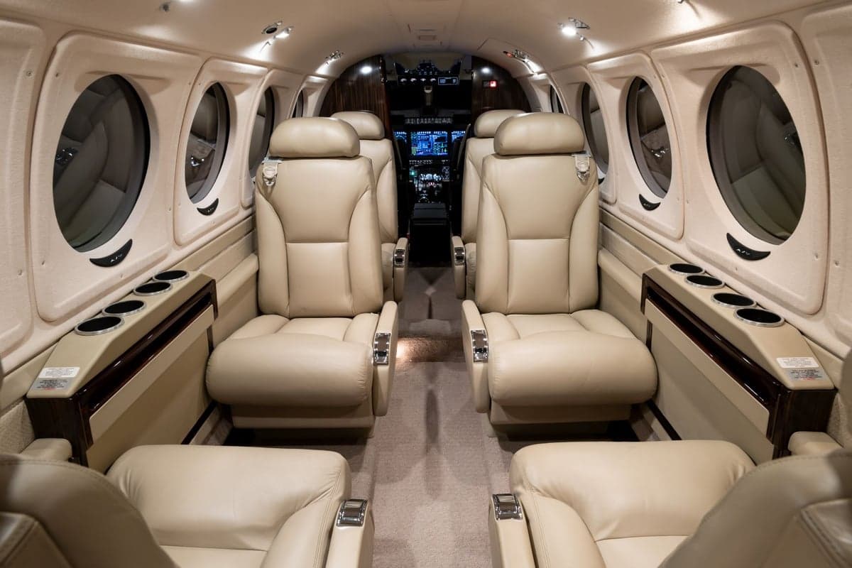 Spacious aircraft cabin featuring comfortable leather seating and elegant design.