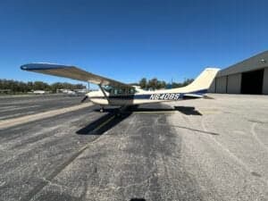 A Cessna 182 Skylane, registration N6408S, parked on the tarmac with a hangar in the background.