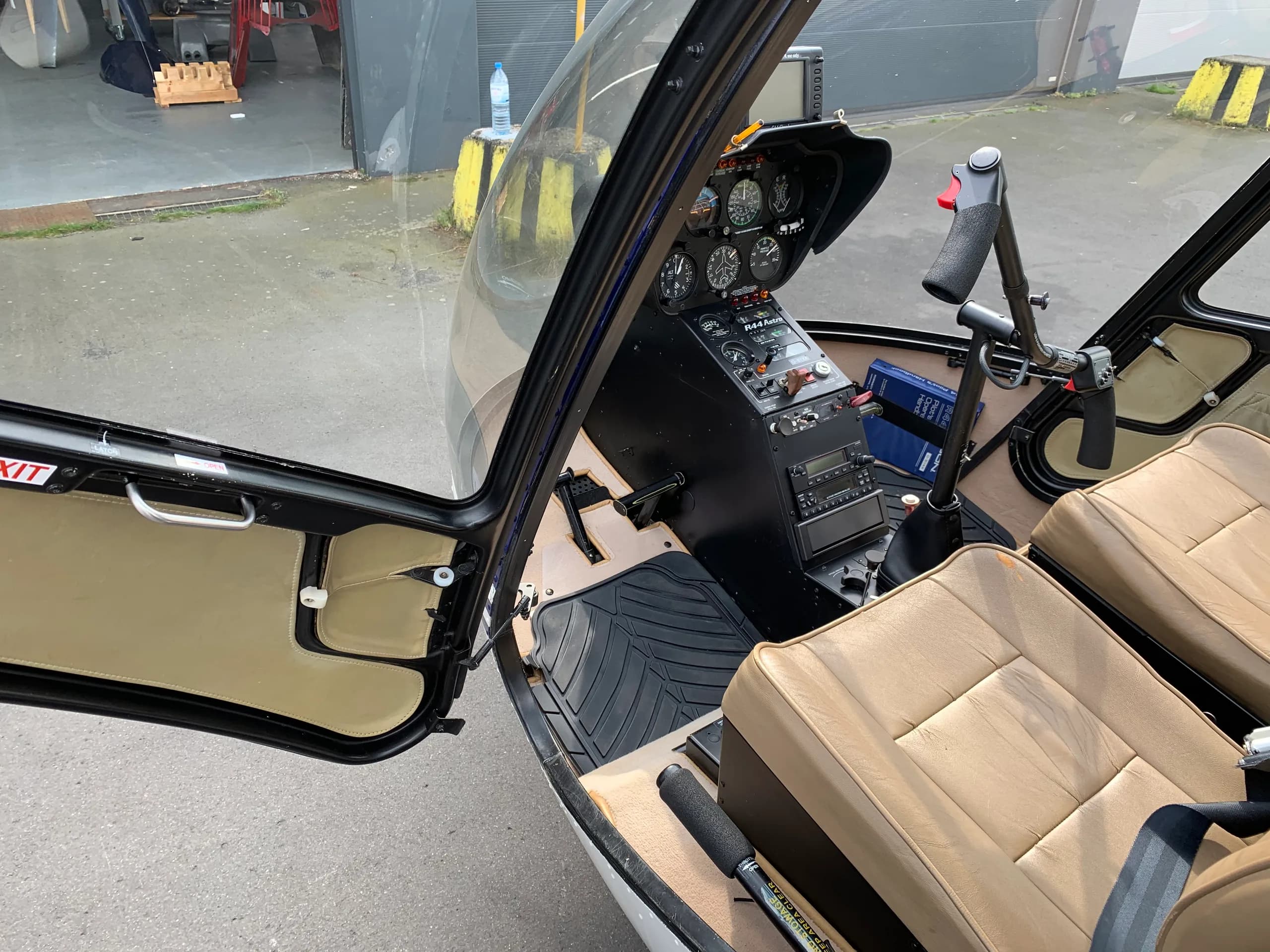 Cockpit view of the Robinson R44 Raven with tan seats.