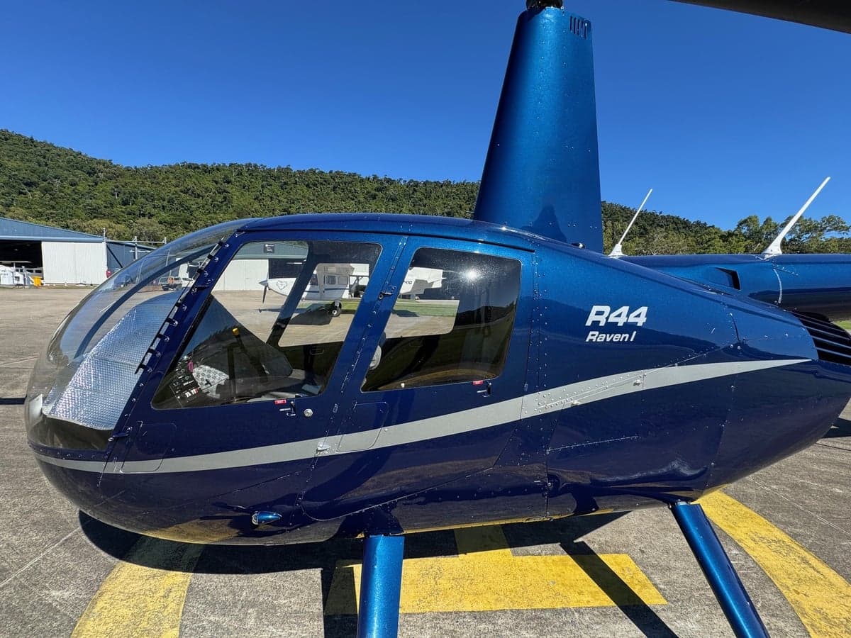 Close-up of a blue R44 Raven I helicopter on the ground.