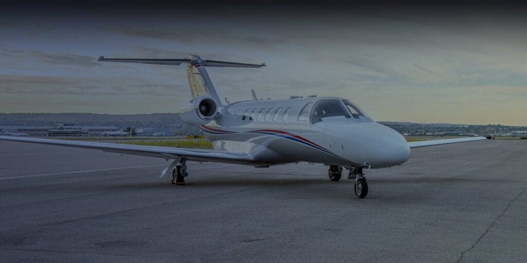 A Challenger aircraft parked on the tarmac with blue accents.