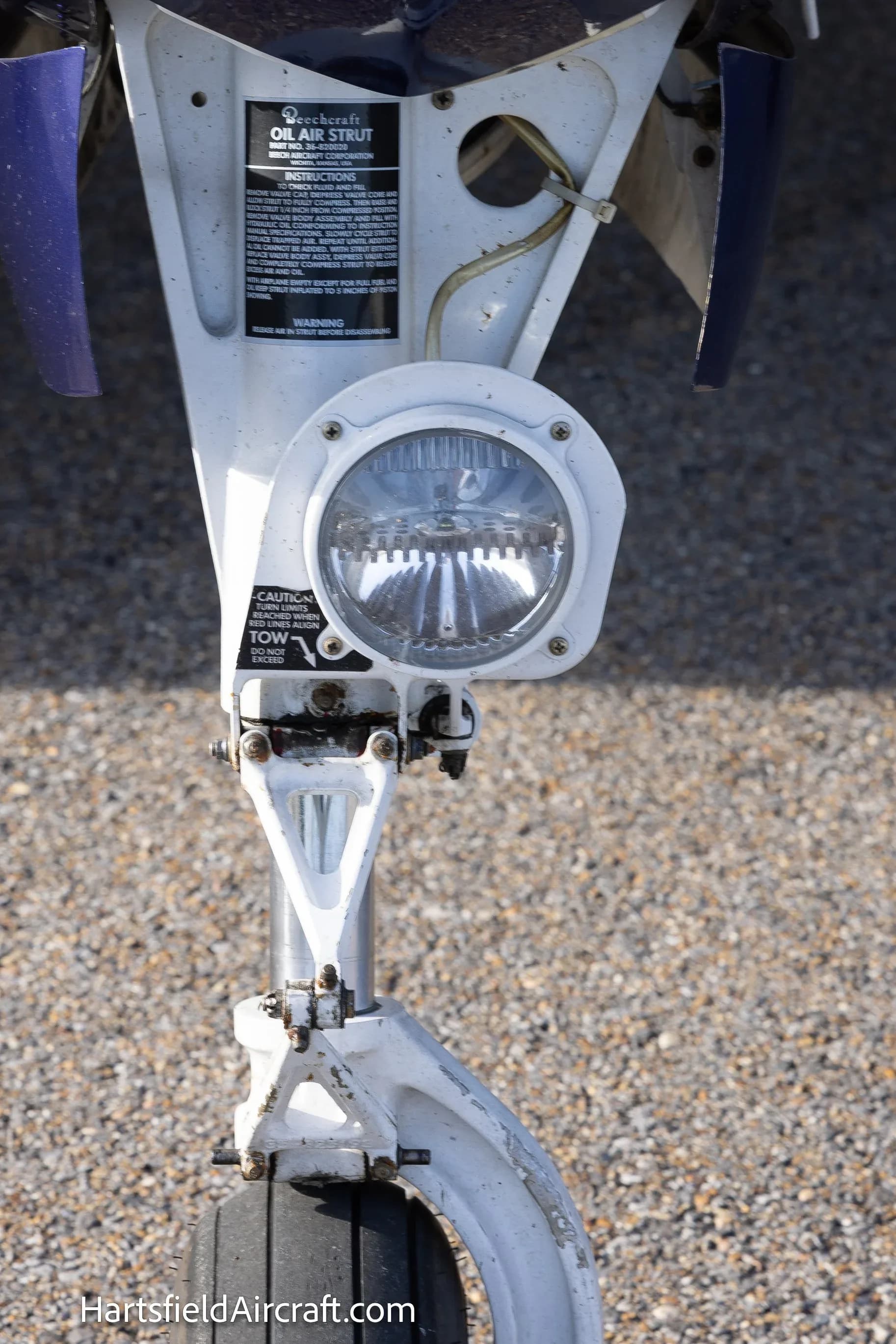Close-up of the nose landing gear and light of a Beechcraft Bonanza G36.