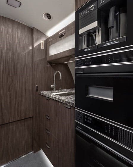 Galley area with countertop, storage, and a bowl of fruit.