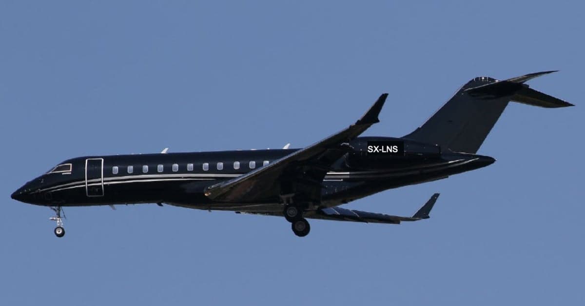 A black Bombardier Global Express XRS aircraft with the tail number SX-LNS in flight.