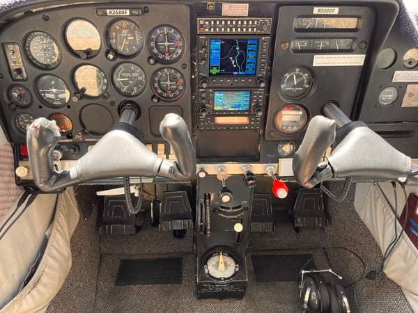 A wide view of the cockpit of the aircraft N2680F, showing the instrument panel, control yokes, and rudder pedals.