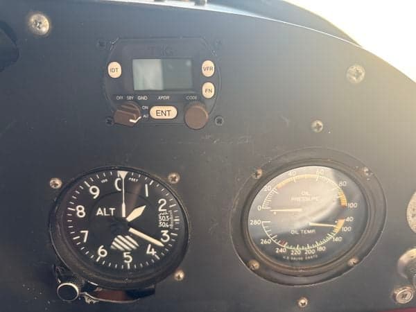 Close up of the aircraft's altimeter and oil pressure gauge.