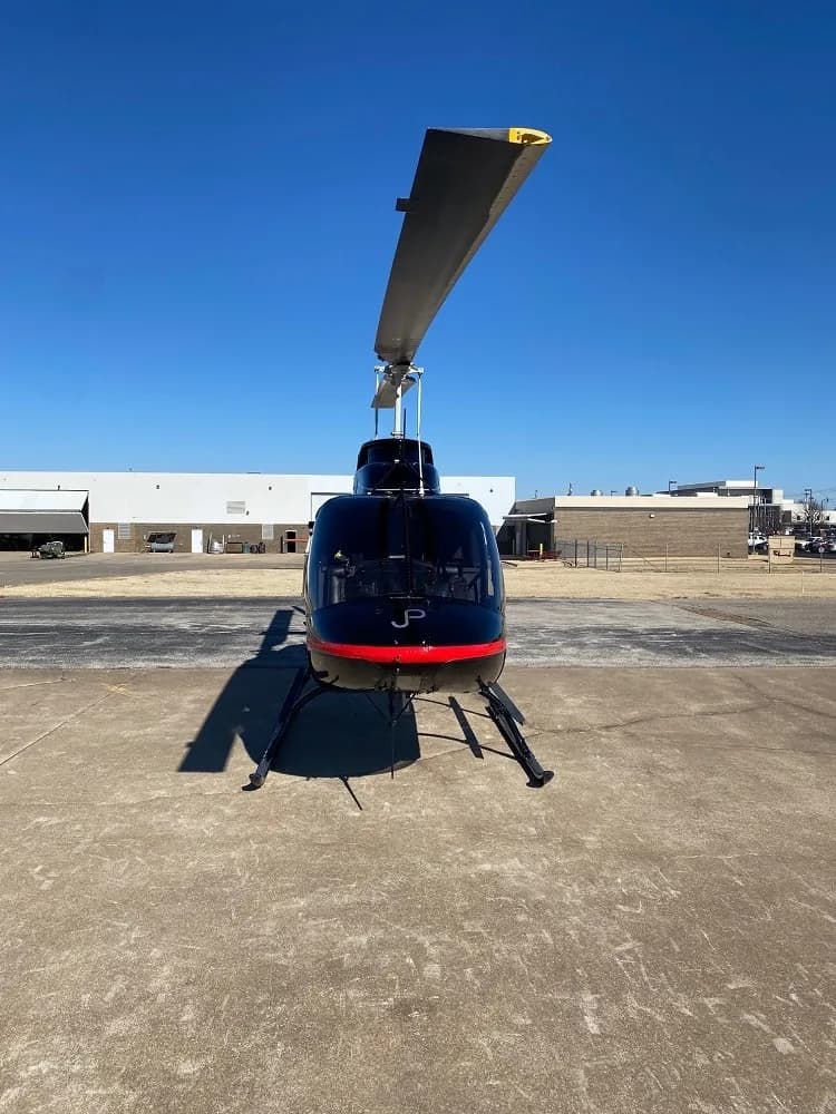 Front view of the Bell 206L-4 helicopter, showing the landing gear and front window.