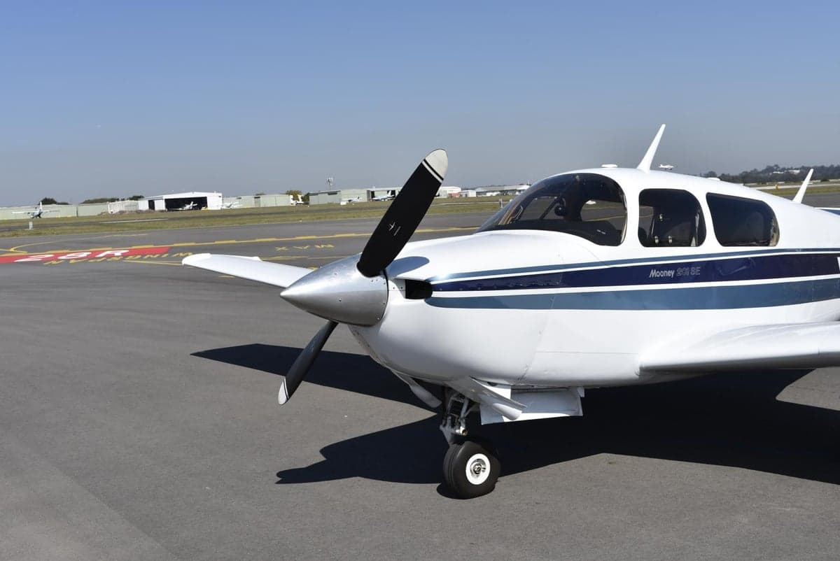 Front view of a Mooney M20J 201 SE aircraft on the tarmac.