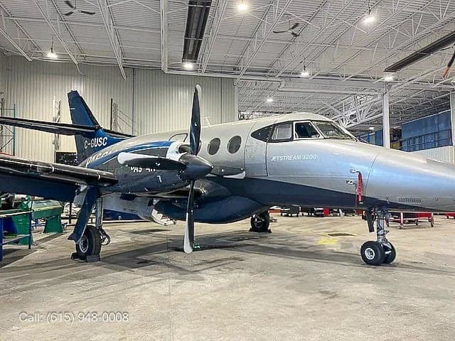 A Jetstream 3200 aircraft parked in a hangar.