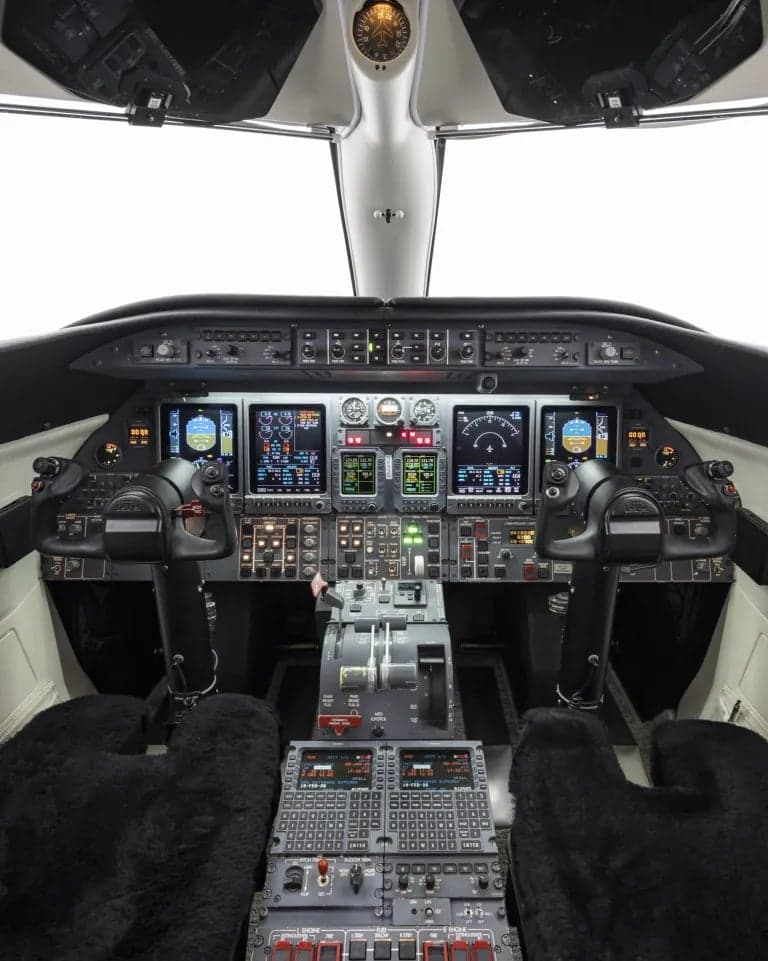 Full view of the aircraft cockpit with instrument panel and controls.