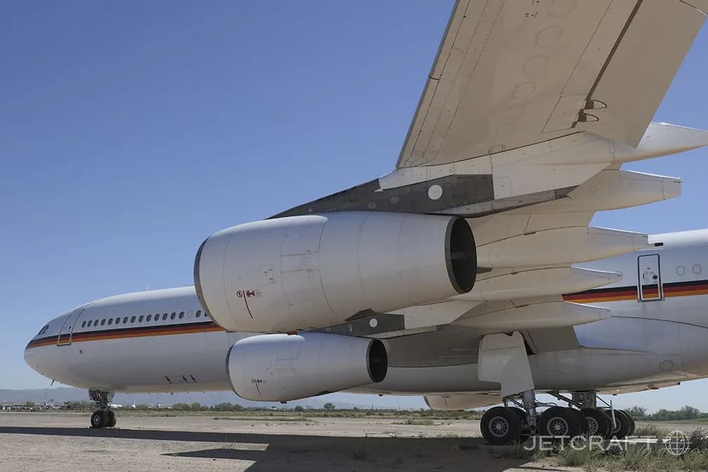 A close-up view of the fuselage, wing, and two engines of a white Airbus A340-300 with a German government livery.