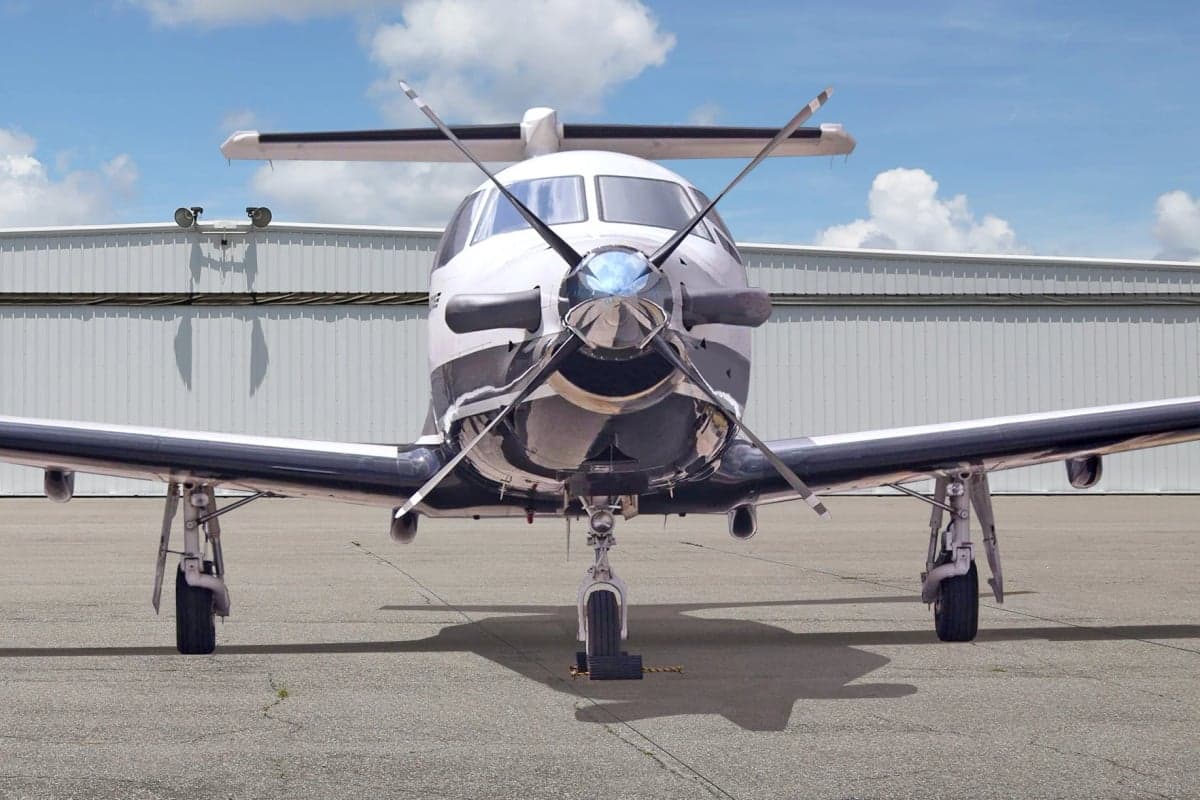 Front view of a Pilatus PC-12 aircraft on the tarmac.