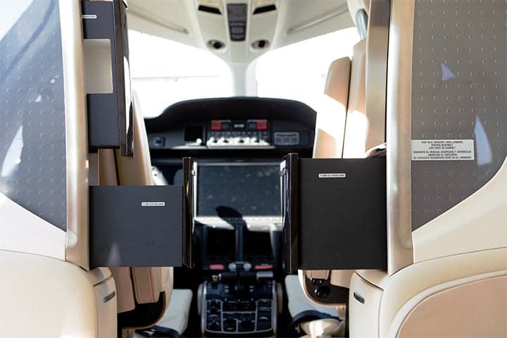 View of the cockpit of a HondaJet from the cabin.