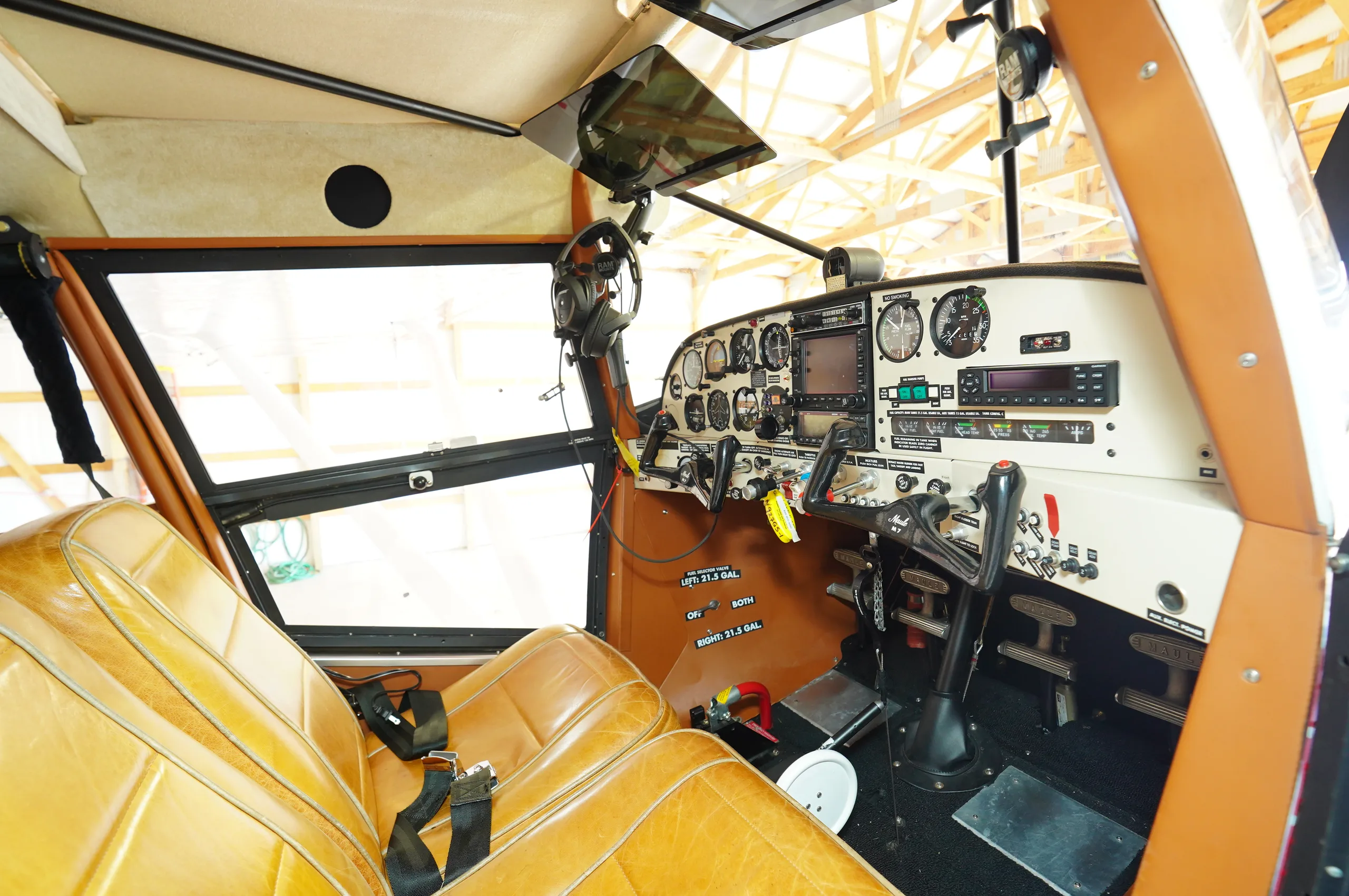 A wide view of the aircraft's cockpit and front cabin seats.