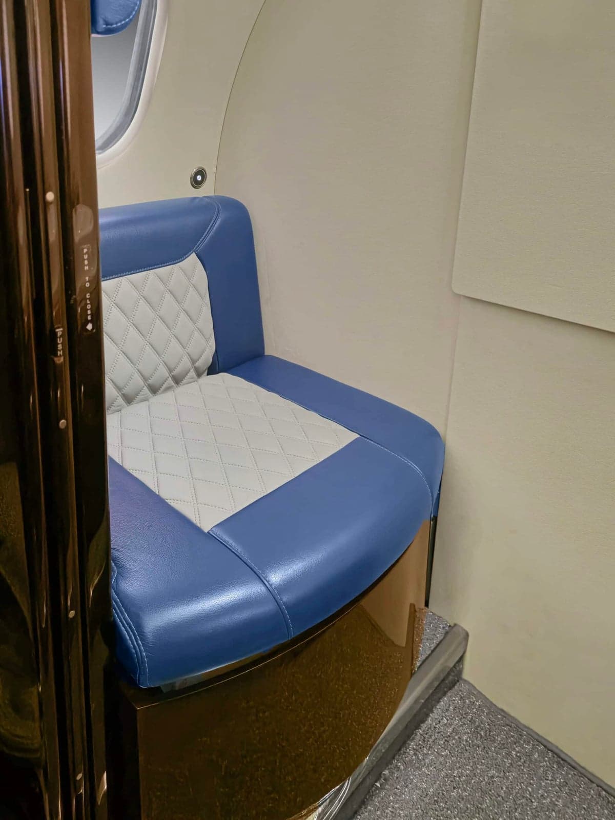 A blue and white seat inside the aircraft.