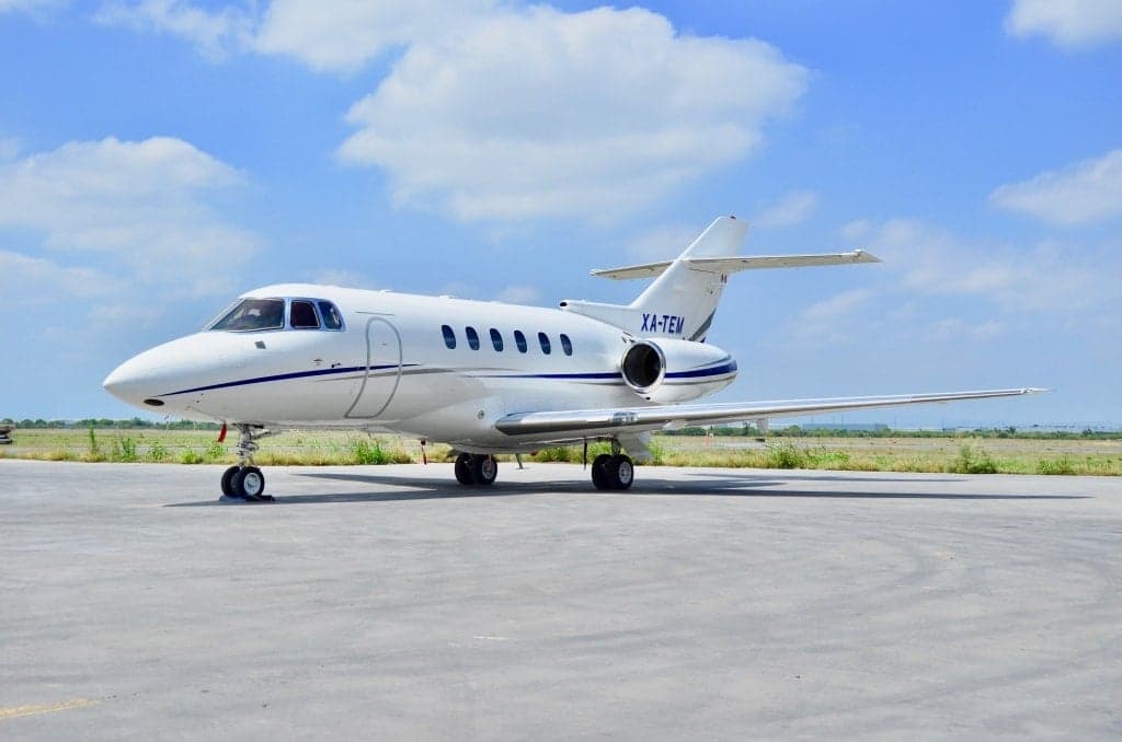 XA-TEM aircraft on the tarmac in bright sunlight.