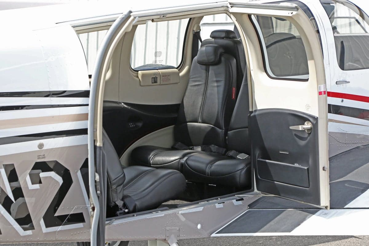 View of the Beechcraft Baron G58 cabin interior with black leather seats.