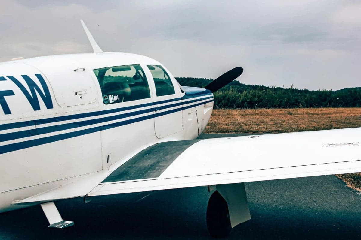 N310FW parked in front of a wooden hangar.
