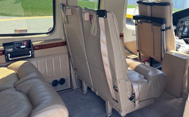 The interior of the helicopter with tan leather seats.