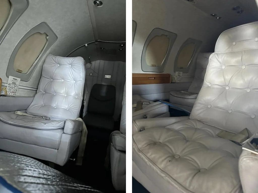 The aircraft's interior features white leather seats.
