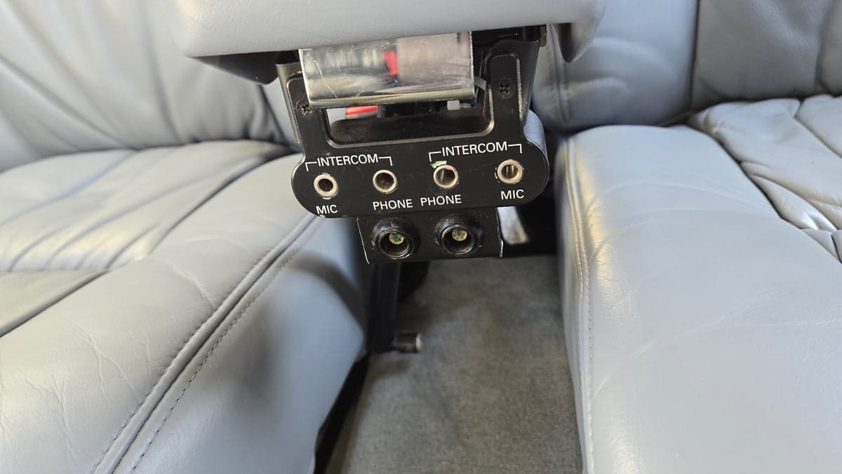 Close-up of the aircraft's intercom and headphone jacks between the seats.