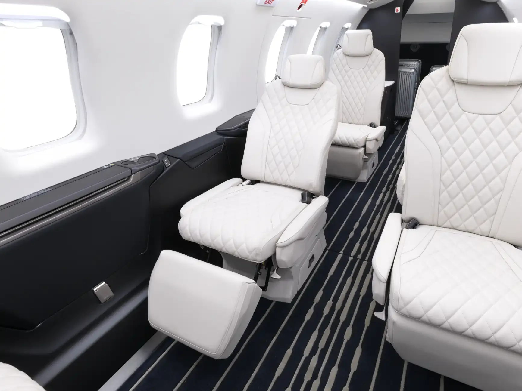 View of the aircraft interior with white leather seats.