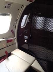 View of the aircraft's interior with a window and seat.