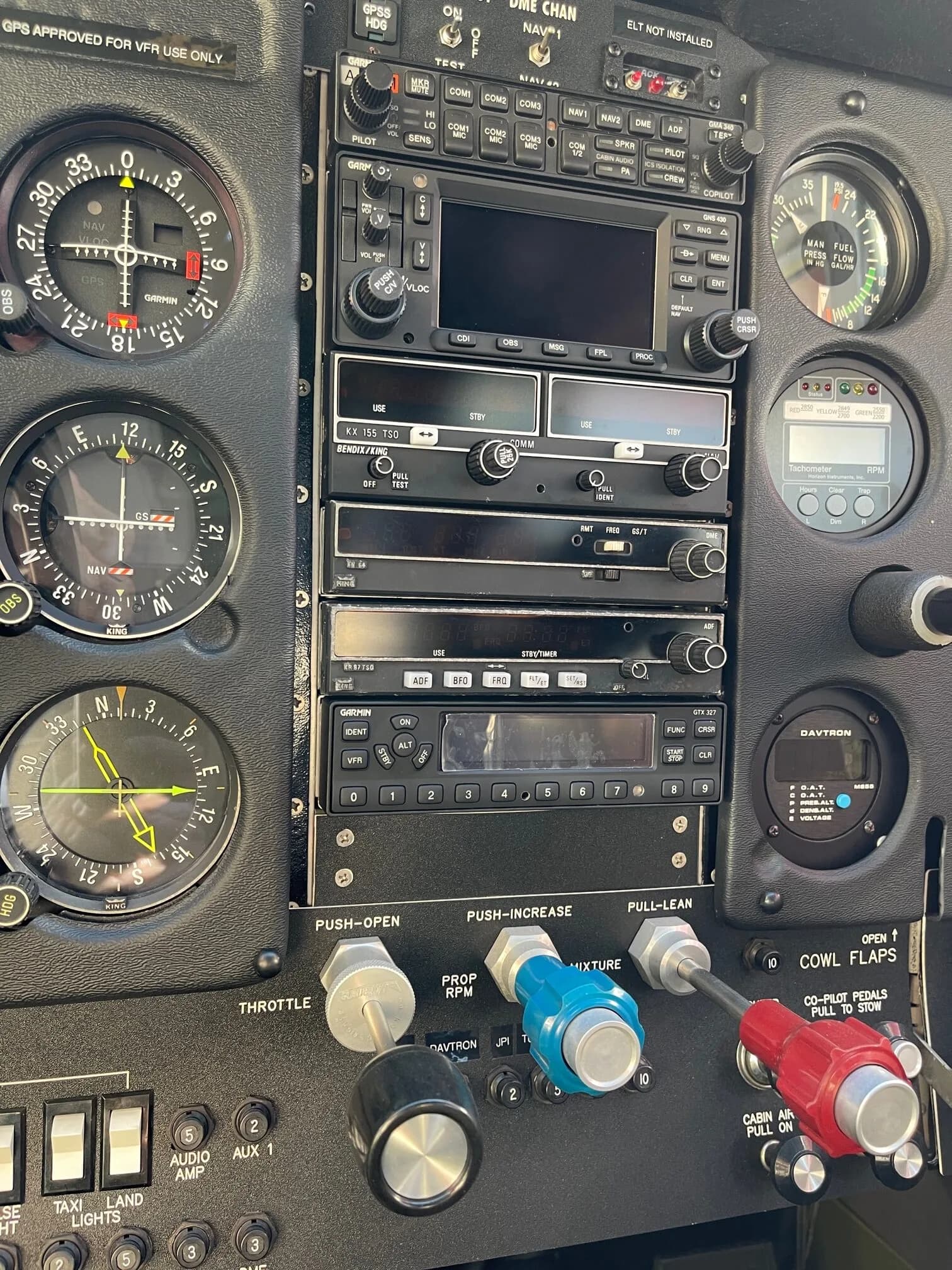Close-up of the gauges and avionics on the instrument panel of an aircraft.
