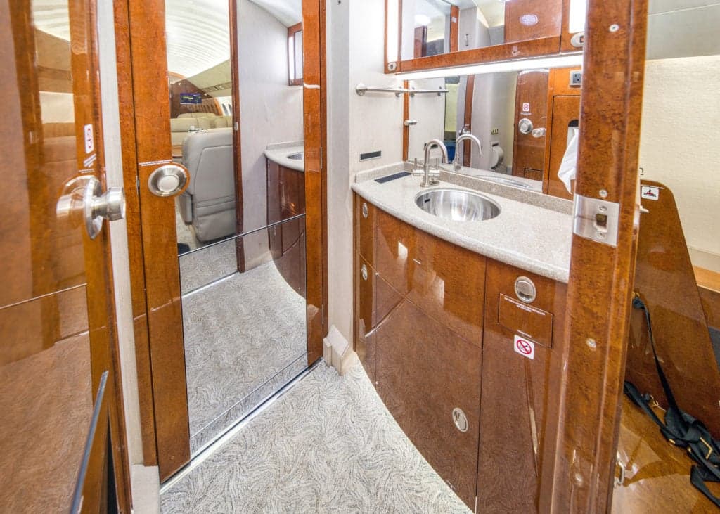 Interior view of the aircraft cabin showing the galley and seating area.
