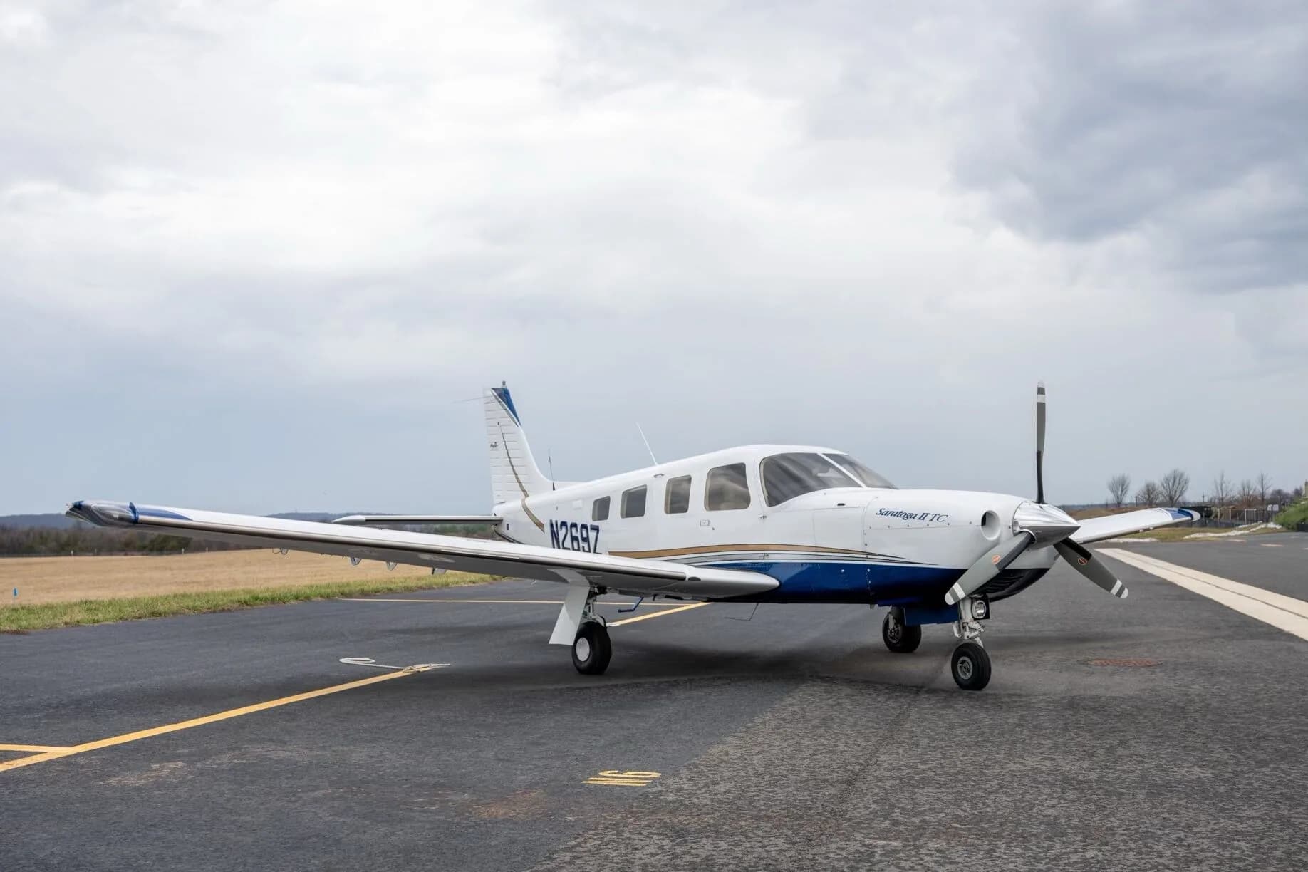 A three-quarter front view of a white Piper Saratoga II TC aircraft, tail number N269Z, parked on an airport tarmac.