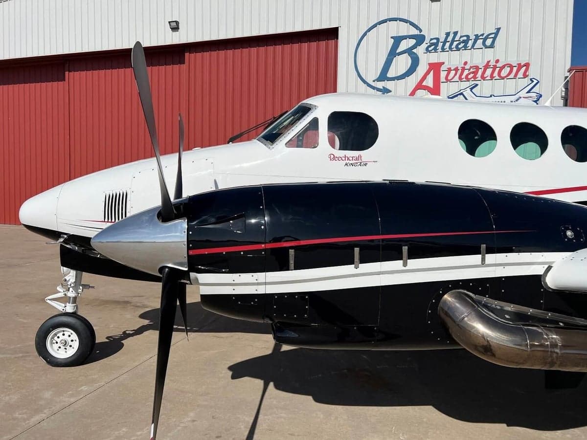 Side view of a Beechcraft King Air with black and white paint scheme.