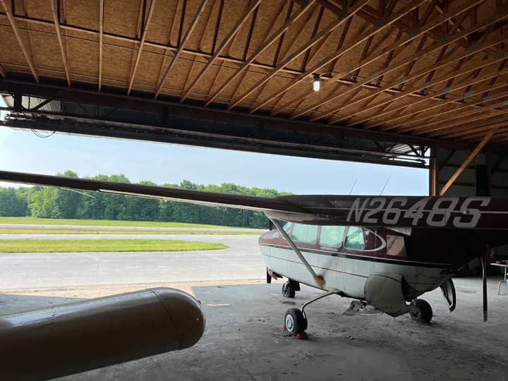 Rear side view of a Cessna aircraft inside a hangar.