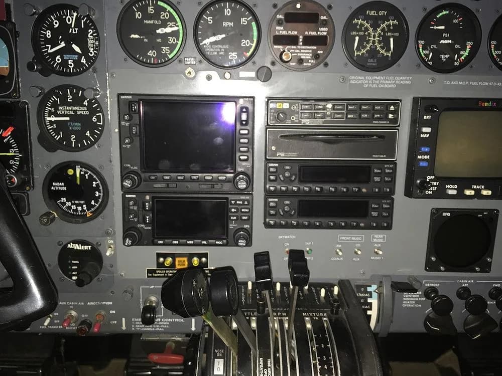A detailed view of the aircraft's cockpit instrument panel, including navigation screens and engine controls.