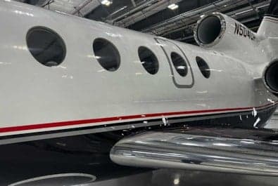 Close up of the side of the N504CP aircraft in a hangar.