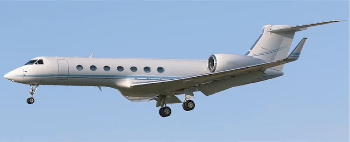 A Gulfstream G550 jet in flight with landing gear down.