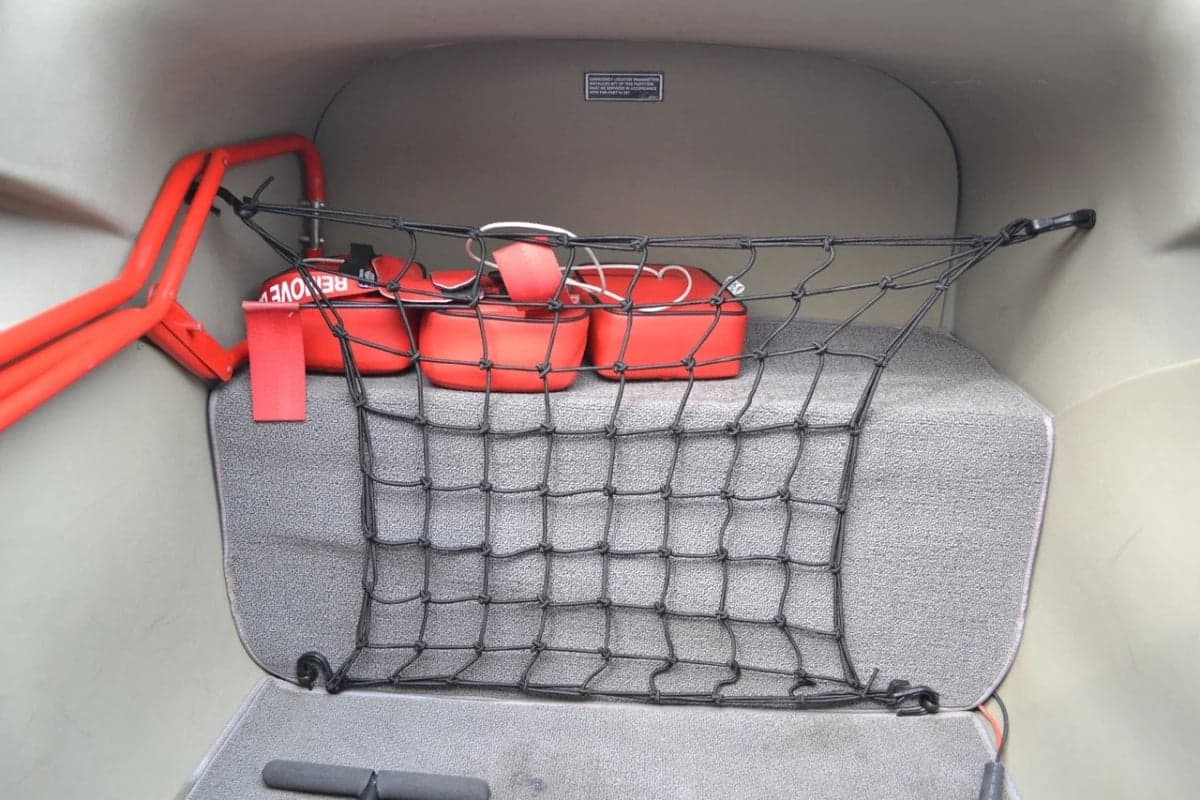 The interior of the Cessna Skylane N2380Y features a cargo net and emergency supplies.