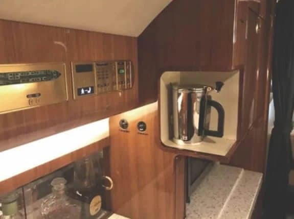Interior view of the aircraft's galley area with a coffee maker and other amenities.