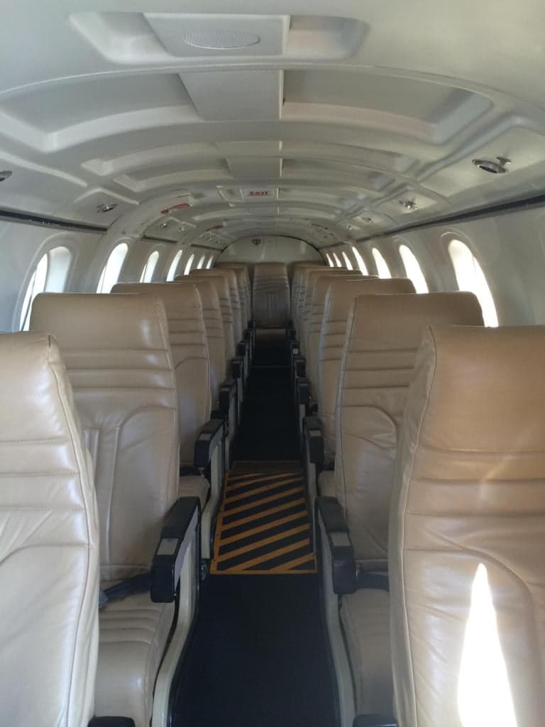 The interior of the King Air aircraft shows rows of passenger seats.