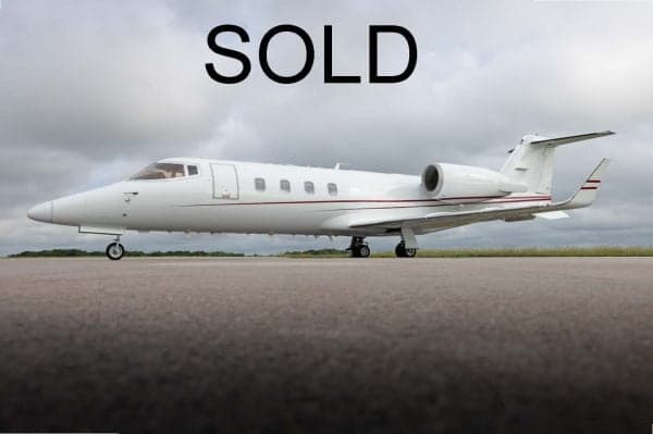 A white jet aircraft is parked on the tarmac with the word SOLD overlaid.