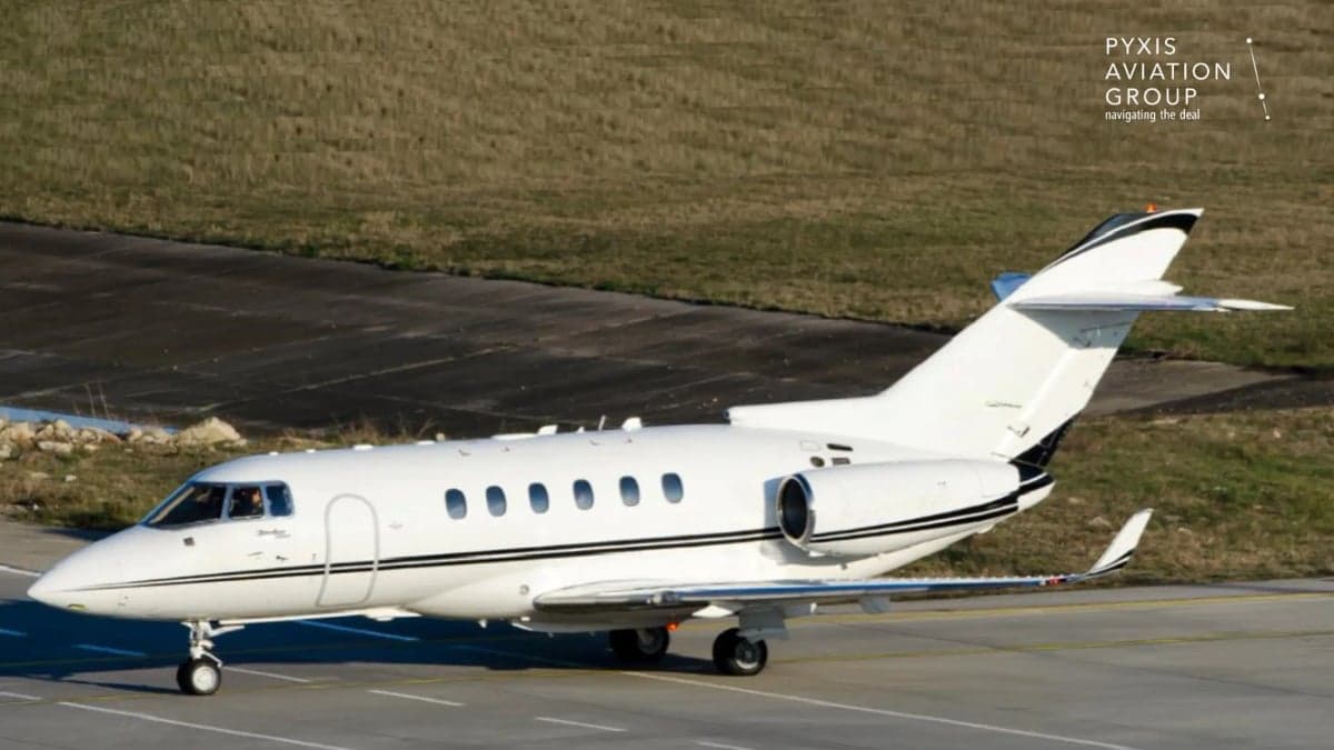 A white Hawker 4000 aircraft is parked on the tarmac.