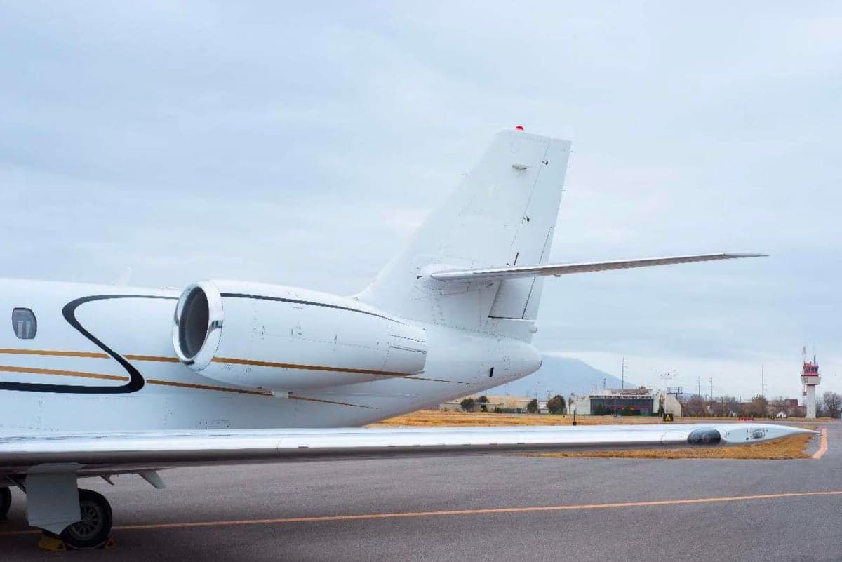 Side view of the tail section of a white jet.