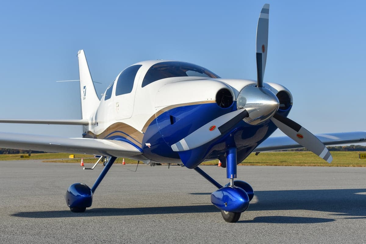 Front view of the Cessna aircraft N915ML with the doors open.