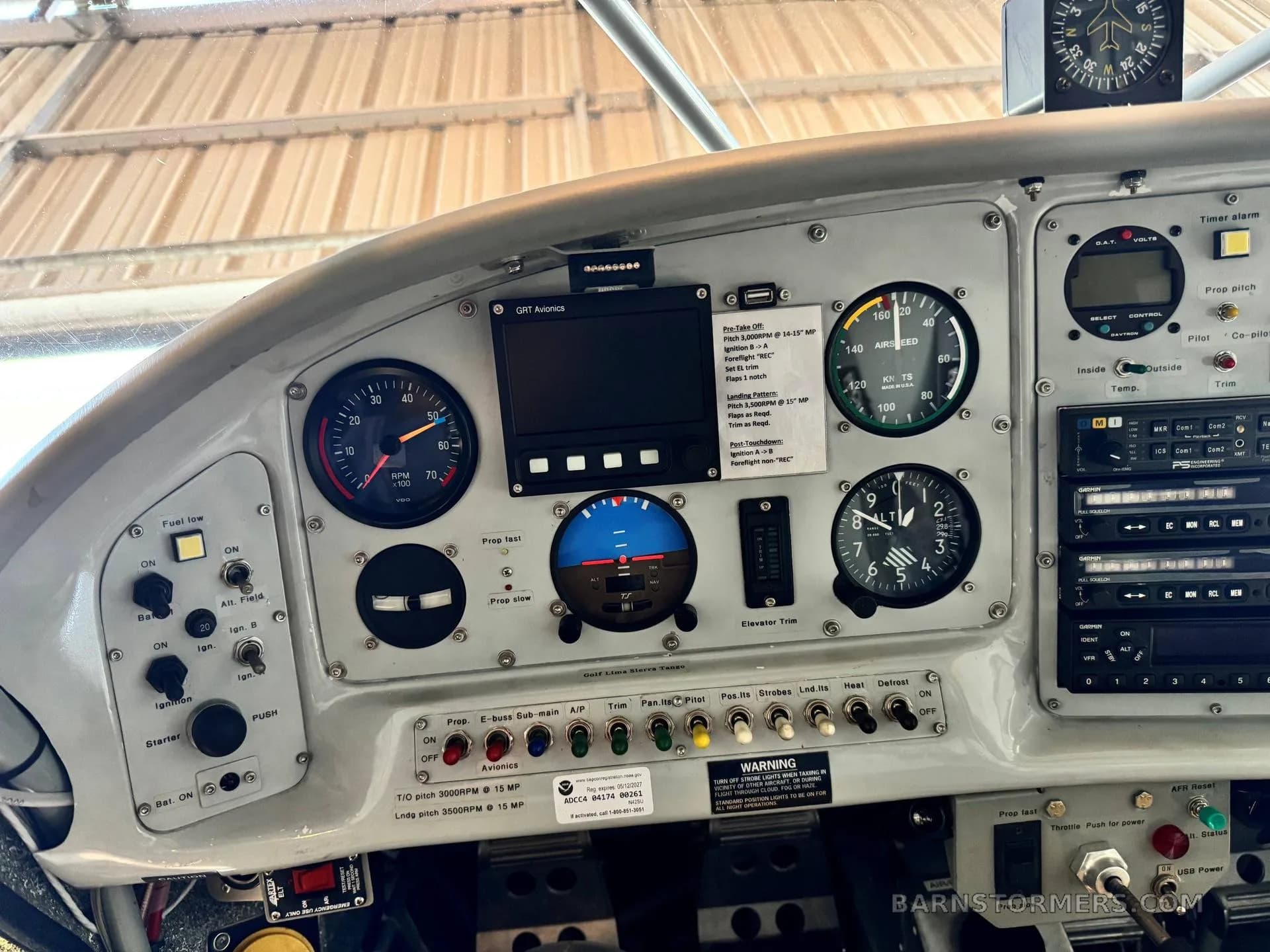 A close-up view of the right side of a light aircraft's instrument panel, showing gauges, switches, and a digital display.